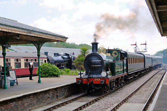 H-class arrives at Horsted Keynes, as the Q-class waits to head south - Brian Lacey - 2 June 2018
